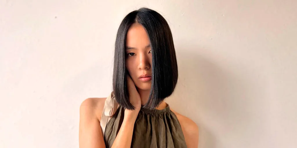 Woman with straight dark hair in a GRWME hair-care editorial image